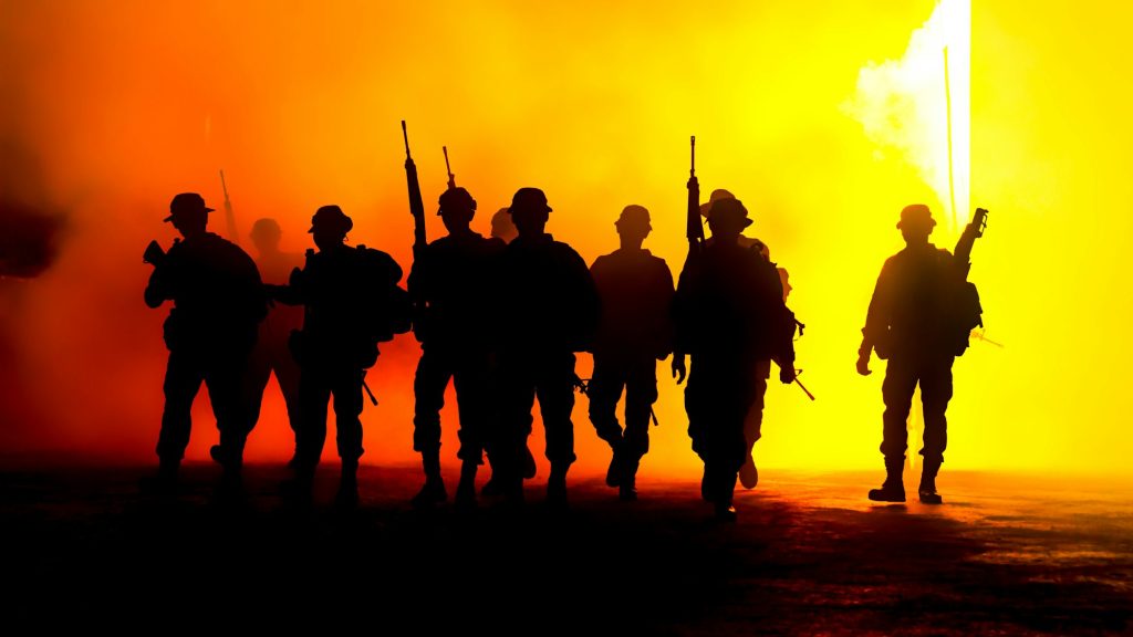 Silhouette Army Soldiers Amidst Smoke At Sunset