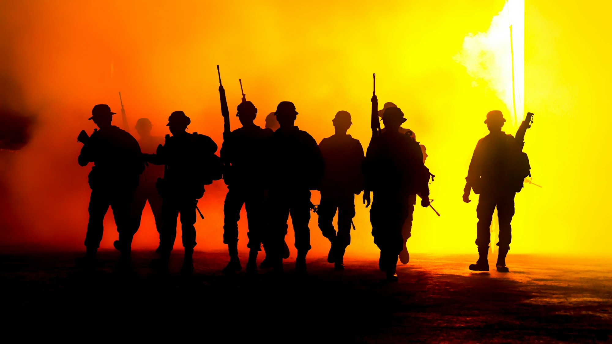 Silhouette Army Soldiers Amidst Smoke At Sunset